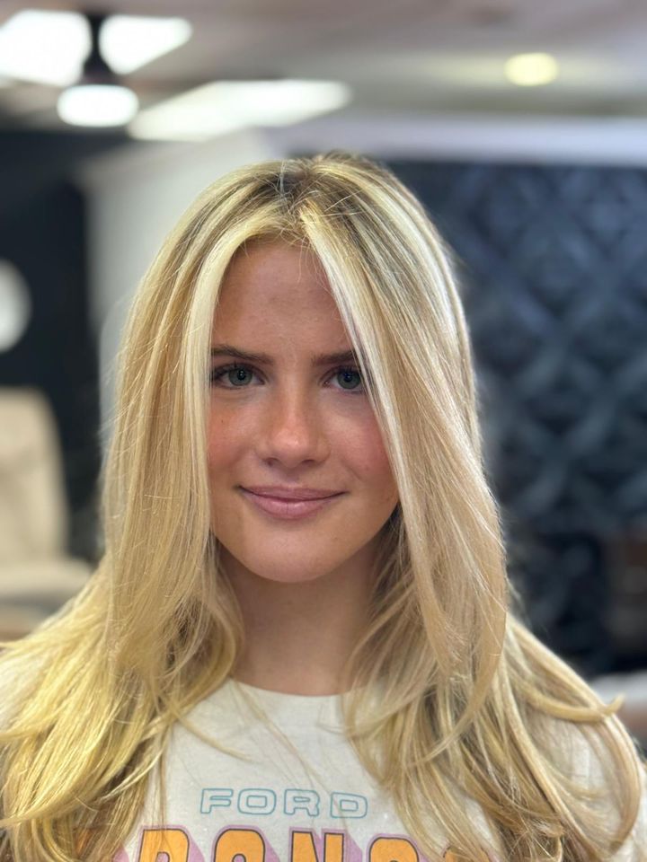Smiling client with bright blonde, face-framing color