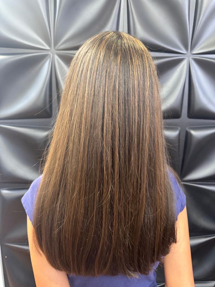 Long, sleek hair with subtle highlights